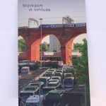 STOPM_2020_418a: A booklet; the front cover of the zine entitled 'Stockport in Solitude' by Jake Bowden. It features a photograph of a train going over the Stockport Viaduct, with Stockport bus station below, taken by Jake in 2020.  Thumbnail